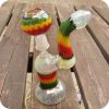 Silver fumed glass concentrate bubbler with Rastafarian themed green, yellow, and red stripes. Comes with glass nail and dome.