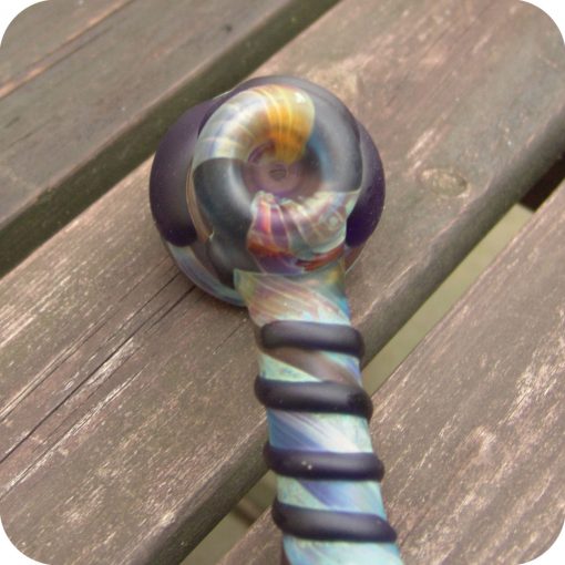 Hammer style glass bubbler featuring full-color jewel-toned glass and decorative elements on the outside